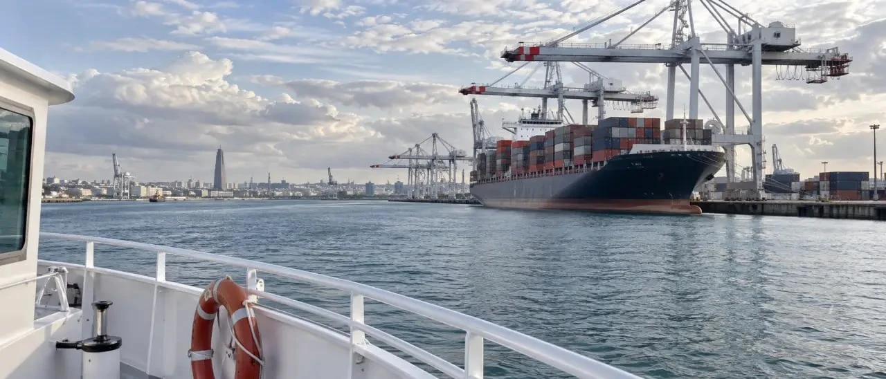 Visite port Havre en bateau avec porte-conteneurs et grues portuaires